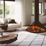Onyx Orbit electric fire hanging or ceiling suspended fire for an open space seen with kitchen space light green walls and wood flooring.