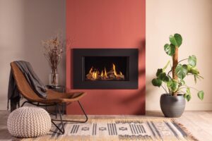 Onyx Avanti 65 Gas inset fire Expression frame with beige walls, red accent wall, and light wood floor.